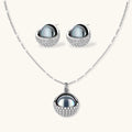 Necklace and stud earrings set with silver-gray domed centers in white gold plated eco-brass shells pavé-set with zirconia.