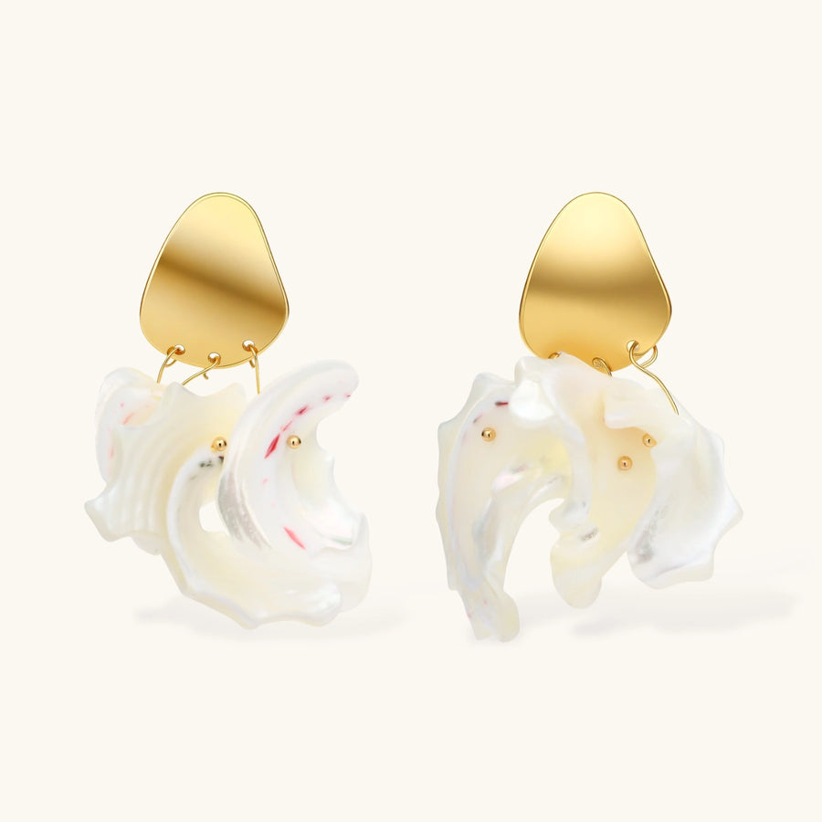 Gold-plated copper earrings with organic pebble studs and natural shell drops on cream background.