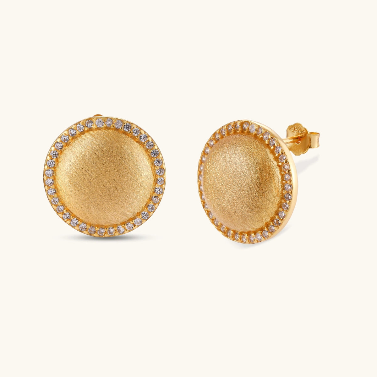 Pair of round dome stud earrings in brushed 18K gold-plated silver with a sparkling CZ halo border, push-back closure.